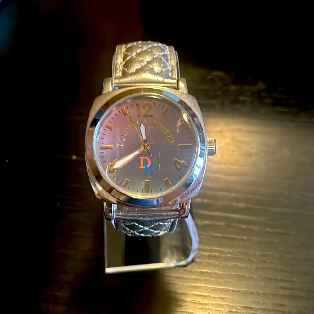 Mirrored two tone face silver Dooney & Bourke watch, quilted silver band.